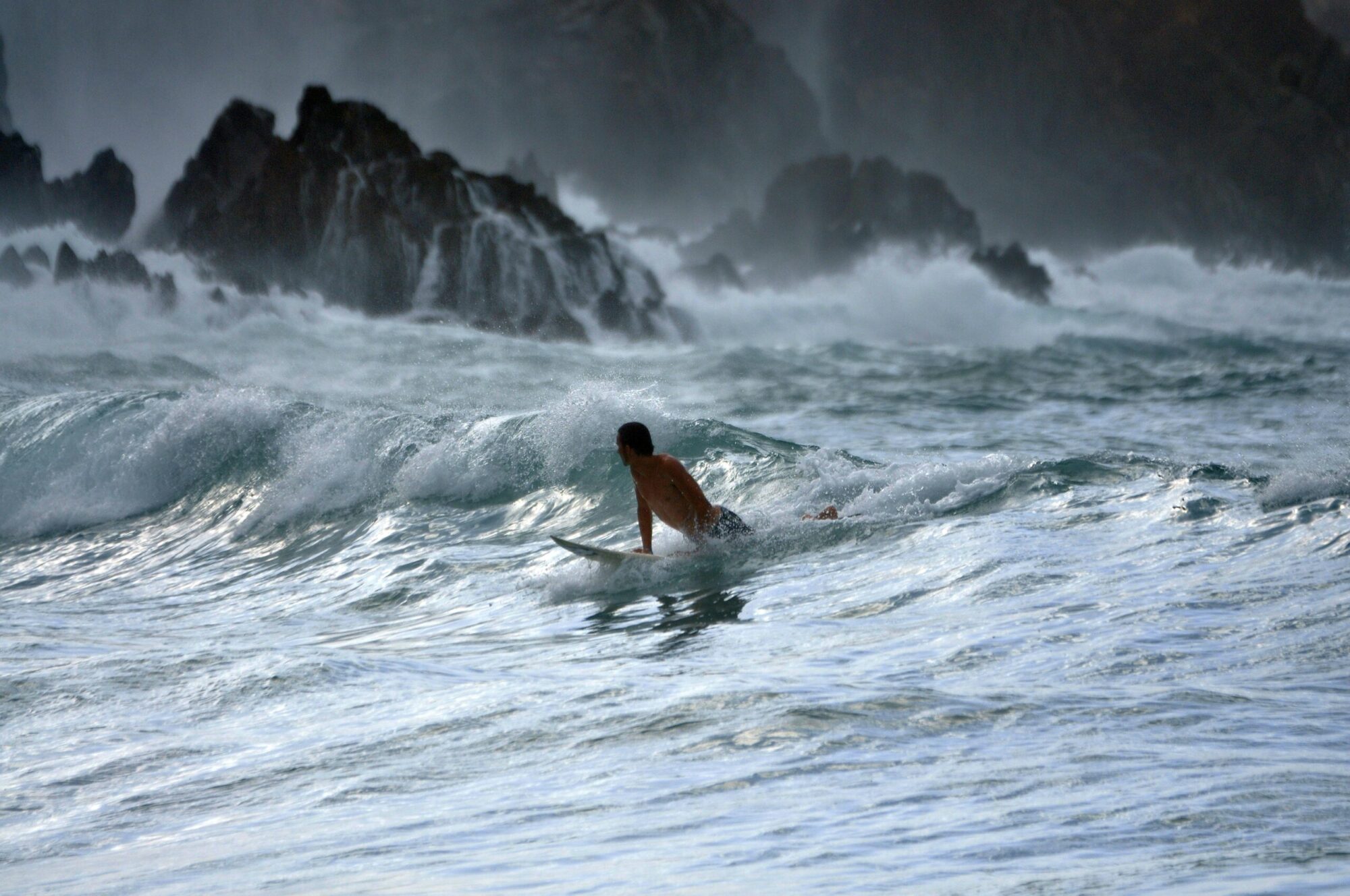 Surfer on the white ocean waves