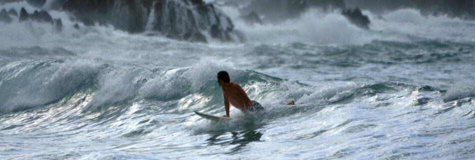 Surfer on the white ocean waves